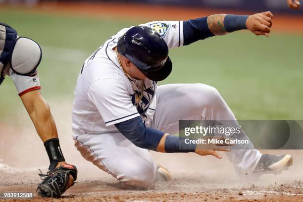 Jesus Sucre of the Tampa Bay Rays slides in safely to score in the eighth inning of a baseball game against the Washington Nationals at Tropicana...