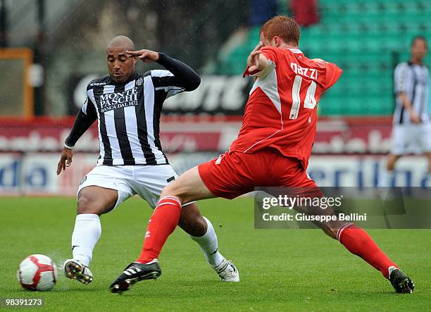 Ferreira Da Silva Reginaldo of Siena and Alessandro Gazzi of Bari in action during the Serie A match between AC Siena and AS Bari at Stadio Artemio...