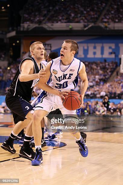 Jon Scheyer of the Duke Blue Devils drives against Zach Hahn of the Butler Bulldogs during the 2010 NCAA Division I Men's Basketball National...