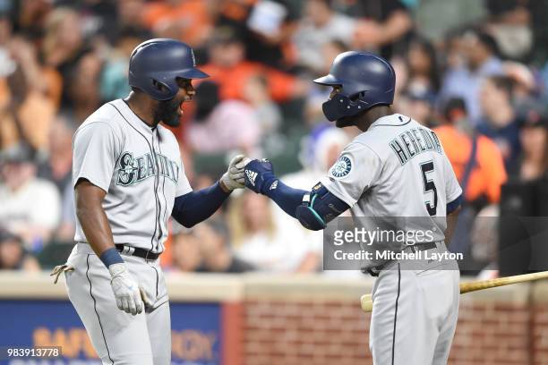 Denard Span of the Seattle Mariners celebrates hitting a solo home run in the sixth inning with Guillermo Heredia during a baseball game against the...