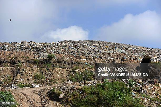 Birds fly above a landfill in Morro do Ceu shantytown, on April 11, 2010 in Niteroi, Brazil. Twenty nine corpses were found at Vicoso Jardim "Bumba"...