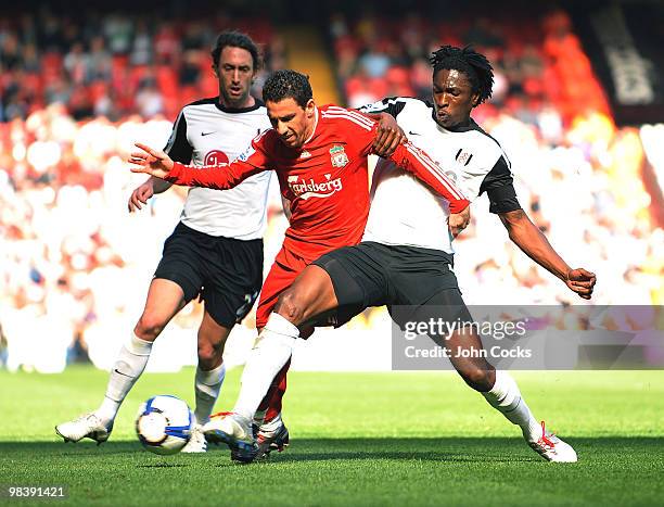 Maxi Rodriguez of Liverpool competes with Dickson Etuhu of Fulham during the Barclays Pemier League match between Liverpool Fulham at Anfield on...