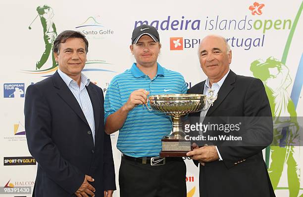 James Morrison of England celebrates with the trophy after winning the final round of the Madeira Islands Open at the Porto Santo golf club on April...