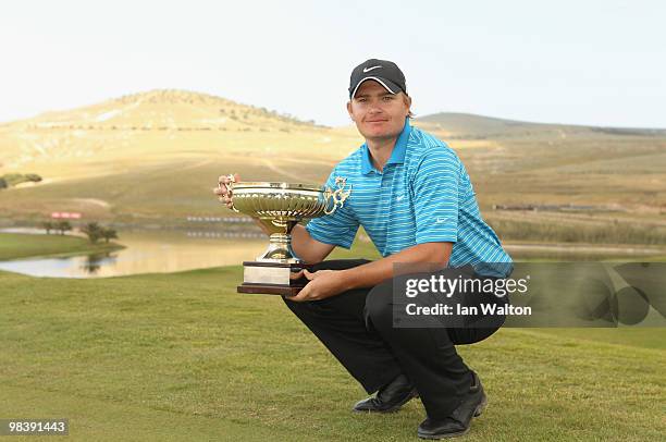 James Morrison of England celebrates with the trophy after winning the final round of the Madeira Islands Open at the Porto Santo golf club on April...