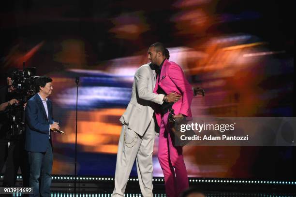 Actor Ken Jeong and Tyson Chandler of the Phoenix Suns present Rudy Gobert of the Utah Jazz with the award for Defensive Player of the Year during...