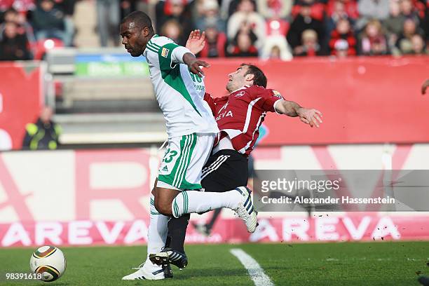 Javier Pinola of Nuernberg battles for the ball with Grafite of Wolfsburg during the Bundesliga match between 1. FC Nuernberg and VfL Wolfsburg at...