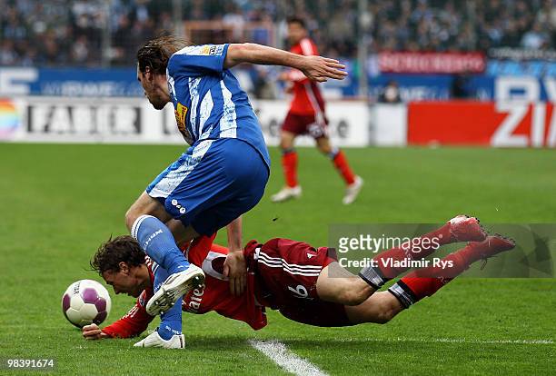Christian Fuchs of Bochum and Marcus Berg of Hamburg battle for the ball during the Bundesliga match between VfL Bochum and Hamburger SV at...