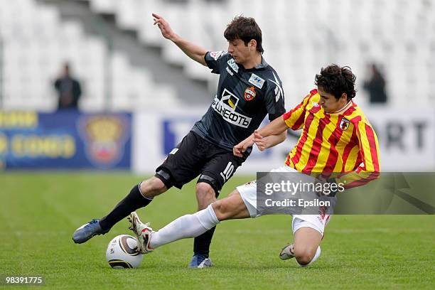 Gheorghe Florescu of FC Alania Vladikavkaz fights for the ball with Alan Dzagoev of PFC CSKA Moscow during the Russian Football League Championship...