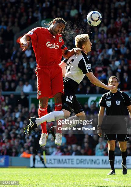 Glen Johnson of Liverpool goes up with Damien Duff of Fulham during the Barclays Pemier League match between Liverpool Fulham at Anfield on April 11,...