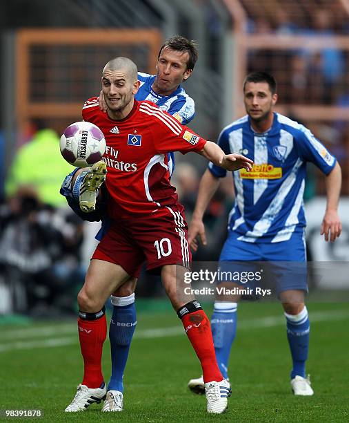 Mladen Petric of Hamburg is tackled by Christoph Dabrowski of Bochum during the Bundesliga match between VfL Bochum and Hamburger SV at Rewirpower...