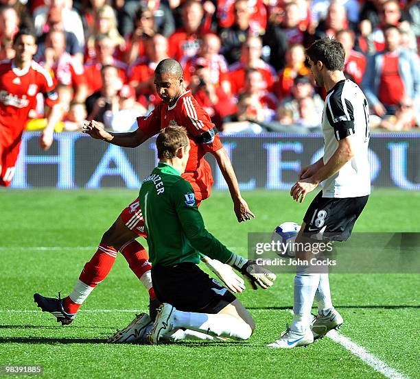 David Ngog of Liverpool competes with Mark Schwarzer of Fulham during the Barclays Pemier League match between Liverpool Fulham at Anfield on April...