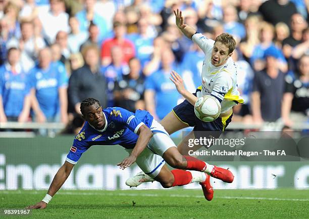 Frederic Piquionne of Portsmouth is tackled by Michael Dawson of Tottenham Hotspur during the FA Cup sponsored by E.ON Semi Final match between...