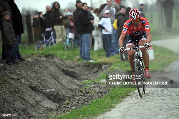 Swiss Fabian Cancellara drinks as he rides on the cobblestoned road during the 108th edition of the Paris-Roubaix cycling race between Compiegne and...