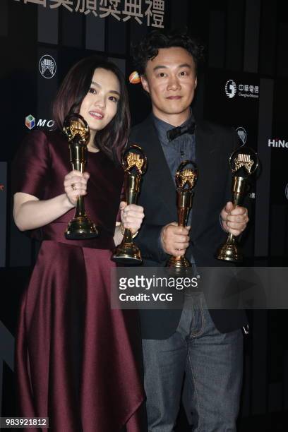 Singer Eason Chan and singer-songwriter Lala Hsu pose with their trophies at backstage of the 29th Golden Melody Awards ceremony on June 23, 2018 in...