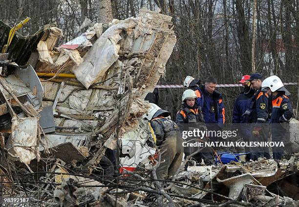 Russian rescuers inspect the wreckage of a Polish government Tupolev Tu-154 aircraft which crashed on April 10 near Smolensk airport, on April 11,...