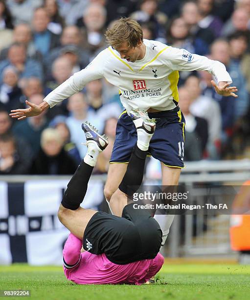 Peter Crouch of Tottenham Hotspur clashes with goalkeeper David James of Portsmouth during the FA Cup sponsored by E.ON Semi Final match between...