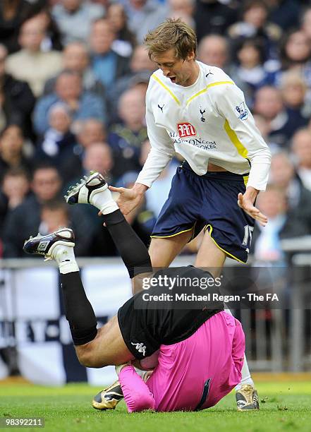 Peter Crouch of Tottenham Hotspur clashes with goalkeeper David James of Portsmouth during the FA Cup sponsored by E.ON Semi Final match between...