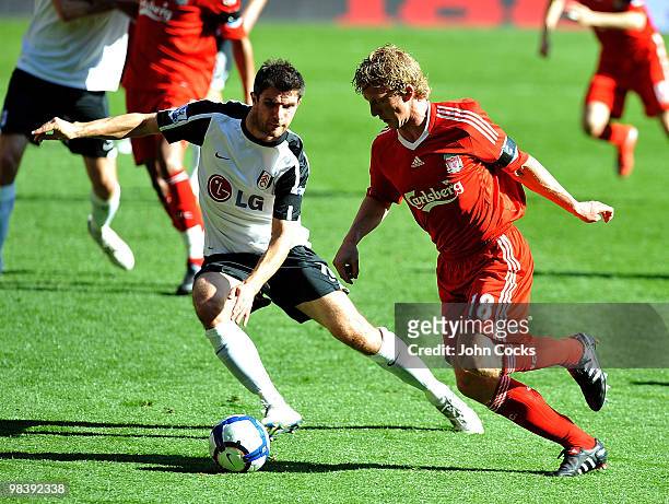 Dirk Kuyt of Liverpool competes with Aaron Hughes of Fulham during the Barclays Pemier League match between Liverpool Fulham at Anfield on April 11,...