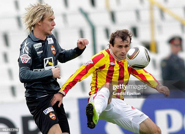 Georgi Bazayev of FC Alania Vladikavkaz fights for the ball with Milos Krasic of PFC CSKA Moscow during the Russian Football League Championship...