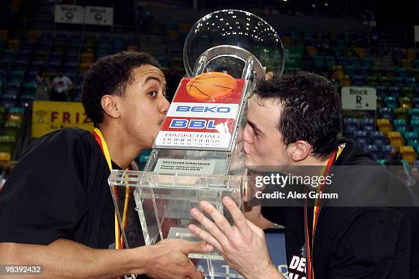 Brian Roberts and Karsten Tadda of Brose Baskets Bamberg kiss the trophy after winning the Beko BBL Top Four basketball tournament against Deutsche...