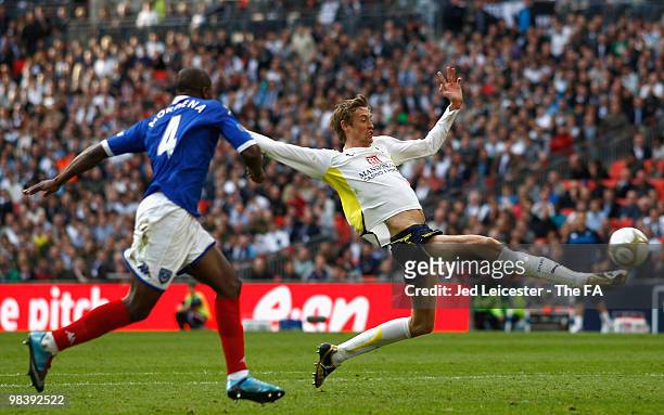 Aaron Mokoena of Portsmouth runs after Peter Crouch of Tottenham Hotspur as he stretches to control the ball during the FA Cup sponsored by E.ON Semi...