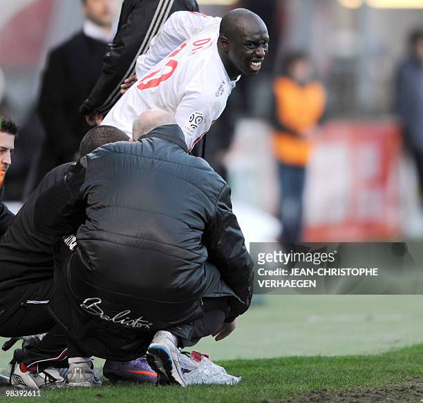 Nancy' Senegalese forward Issiar Dia grimaces in pain after being injured during the French L1 football match Nancy vs. Auxerre at Marcel-Picot...