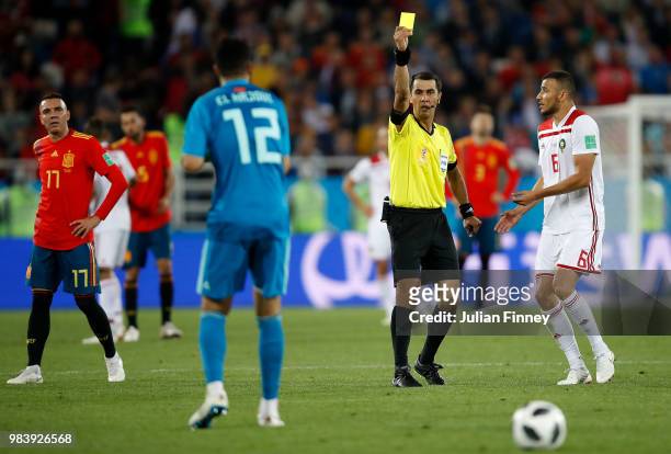 Referee Irmatov Ravshan gives a yellow card to Ahmed Tagnaouto of Morocco during the 2018 FIFA World Cup Russia group B match between Spain and...