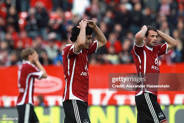 Ilkay Guendogan of Nuernberg reacts with his team mates Albert Bunjaku and Marcel Risse during the Bundesliga match between 1. FC Nuernberg and VfL...