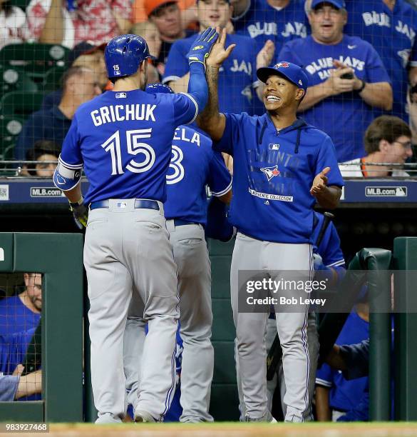 Randal Grichuk of the Toronto Blue Jays receives a high five from Marcus Stroman after hitting a two-run home run against the Houston Astros in the...