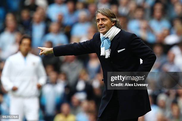 Manchester City manager Roberto Mancini instructs his team during the Barclays Premier League match between Manchester City and Birmingham City at...