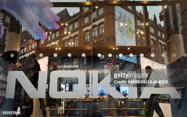 In this file photo taken on October 21, 2010 the logo of Finland's mobile phone maker Nokia is seen on the window of Nokia flagship store in...