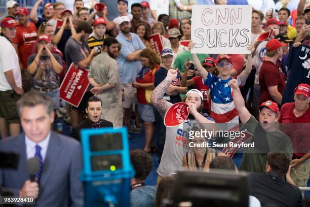 People shout behind CNN reporter Jim Acosta before a campaign rally for South Carolina Governor Henry McMaster featuring President Donald Trump at...