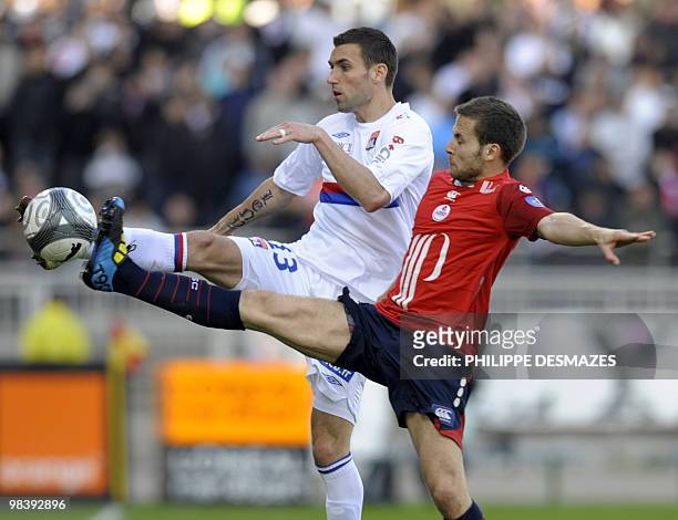 Lyon's French defender Anthony Reveilliere fights for the ball with Lille's French midfielder Yohan Cabaye during the French L1 football match Lyon...