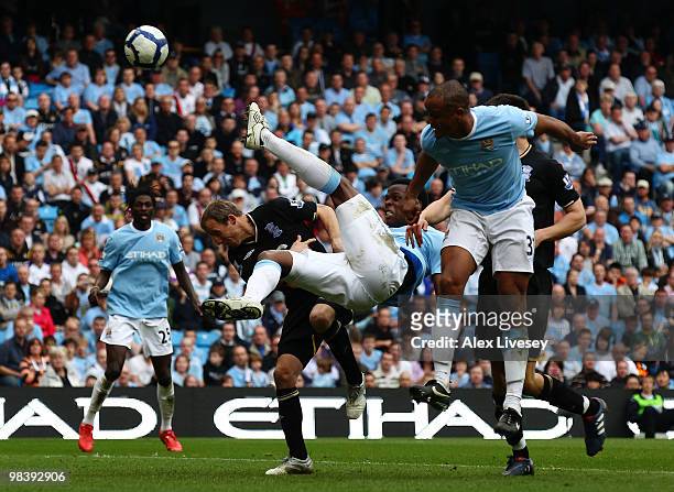 Nedum Onuoha of Manchester City is challenged by Lee Bowyer of Birmingham City during the Barclays Premier League match between Manchester City and...