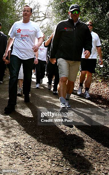 Conservative leader David Cameron , Britain's opposition party, walks with Former England cricketer Ian Botham as they take part in the 'Forget Me...