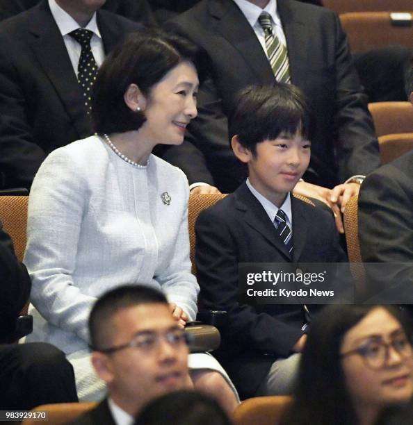 Prince Hisahito , grandson of Japan's Emperor Akihito, and his mother Princess Kiko are pictured at the venue of a concert marking the 60th...