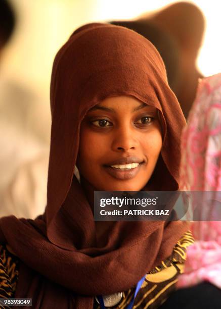 Sudanese election observer waits outside a polling station in Khartoum on April 11 after it was closed early for technical and logistical reasons....