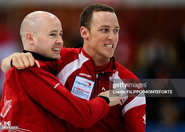 Canada's first Nolan Thiessen hugs skipper Kevin Koe after defeating Norway in the Men's world championship final on April 11, 2010 in Cortina...