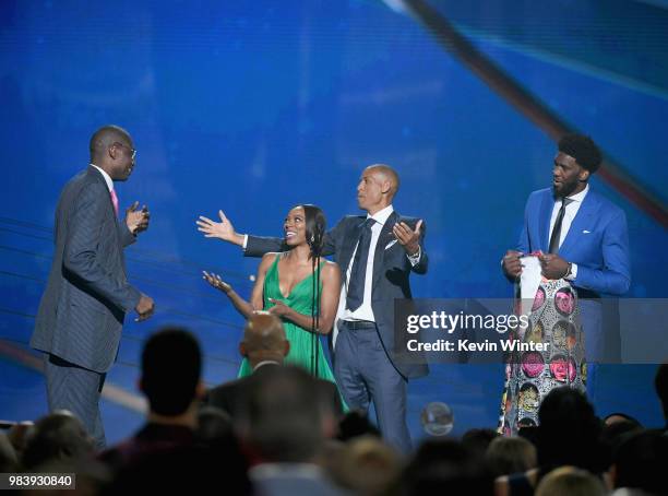 Sager Strong award winner Dikembe Mutombo accepts his jacket from Yvonne Orji, Reggie Miller, and Joel Embiid onstage at the 2018 NBA Awards at...