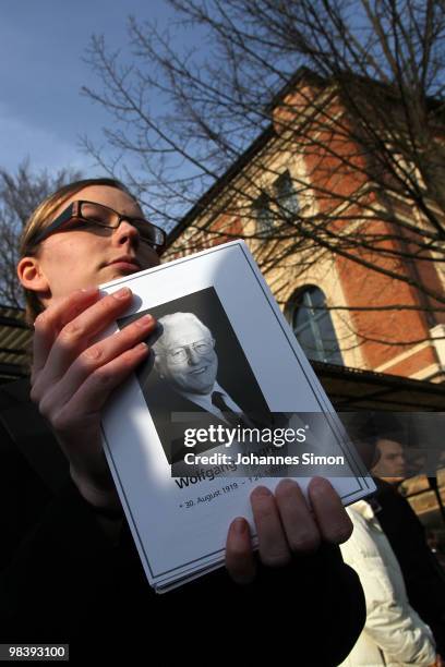 Hostess of the festival opera house distributes leaflets with the portrait of Wolfgang Wagner after the funeral service for Wolfgang Wagner at...