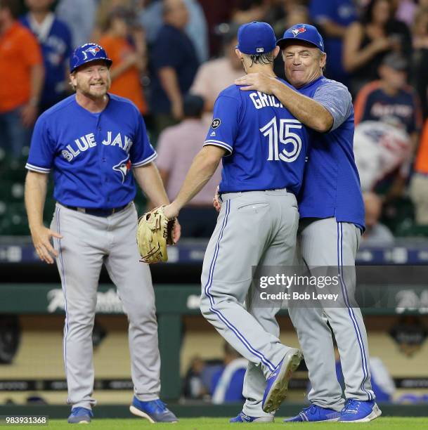 Randal Grichuk of the Toronto Blue Jays receives a hug from manager John Gibbons of the Toronto Blue Jays as they beat the Houston Astros 6-3 at...