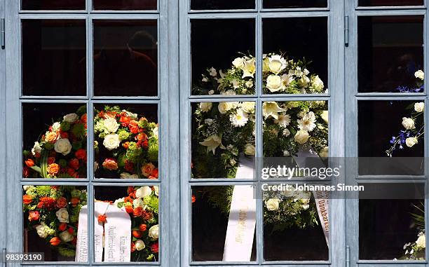 Funeral wreaths are seen through windows during the funeral service for Wolfgang Wagner at festival opera house on April 11, 2010 in Bayreuth,...