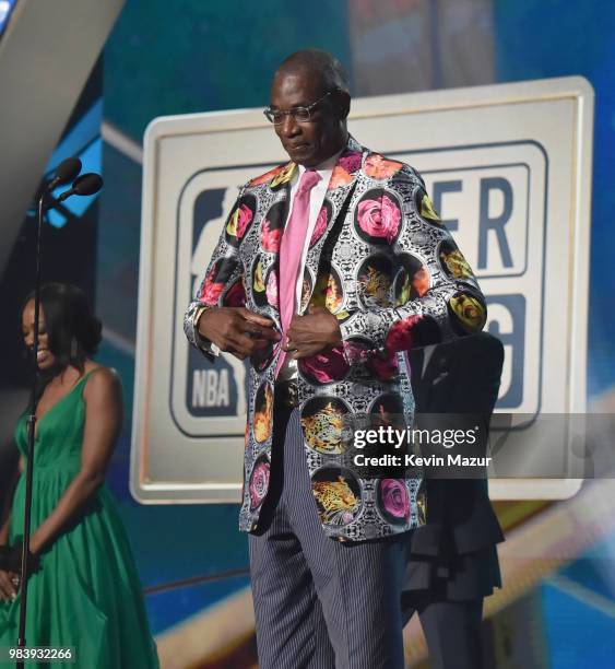 Sager Strong award winner Dikembe Mutombo accepts his jacket from Reggie Miller, Yvonne Orji, and Joel Embiid onstage at the 2018 NBA Awards at...