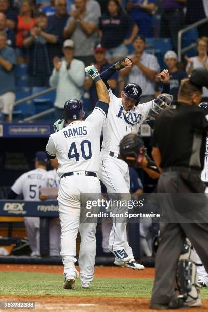 Wilson Ramos of the Rays celebrates with Daniel Robertson after hitting his second home run against his former team during the MLB regular season...