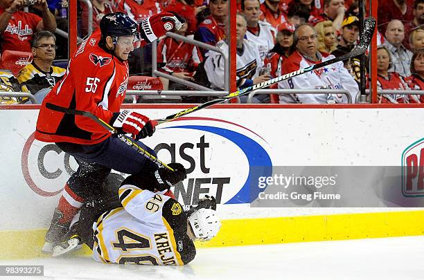 Jeff Schultz of the Washington Capitals checks David Krejci of the Boston Bruins at the Verizon Center on April 11, 2010 in Washington, DC.