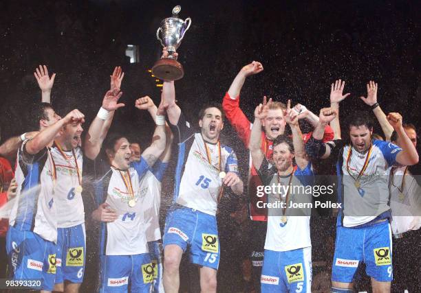 The team of Hamburg celebrates after winning the DHB Cup Final match between Rhein-Neckar Loewen and HSV Hamburg at the Color Line Arena on April 11,...