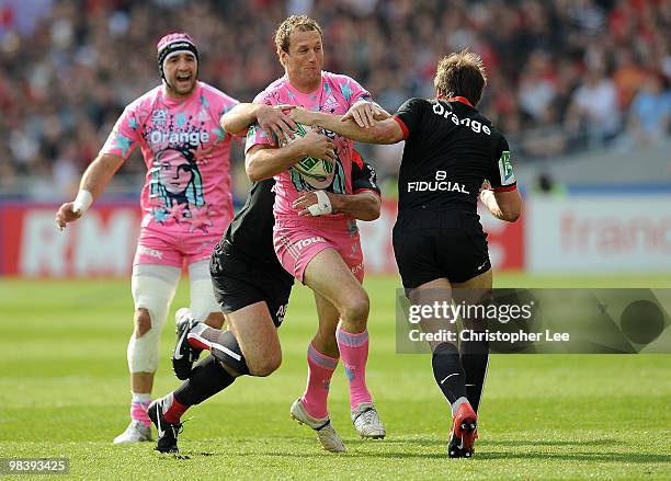 Mark Gasnier of Francais is tackled by Florian Fritz and Vincent Clerc of Toulousain during the Heineken Cup Quarter Final match between Stade...