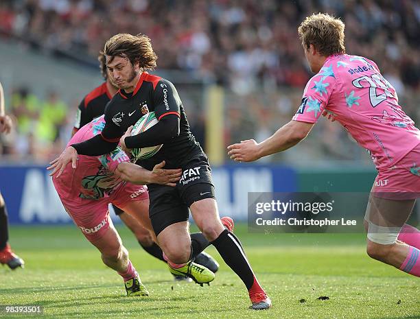 Maxime Medard of Toulousain is tackled by Sylvain Marconnet and Simon Taylor of Francais during the Heineken Cup Quarter Final match between Stade...