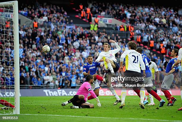 Peter Crouch of Tottenham Hotspur scores a disallowed goal against goalkeeper David James of Portsmouth during the FA Cup sponsored by E.ON Semi...