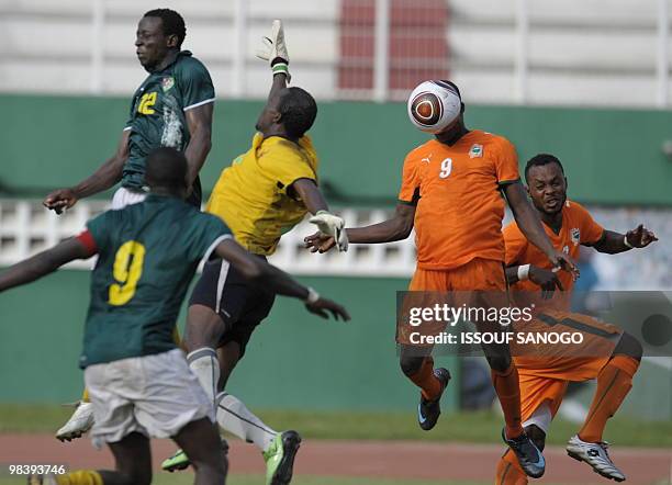 Ivory Coast's players National football team players Tiezan Ladji Kone and Serge Pascal fight for the ball with Togolese team goalkeeper Essofa and...